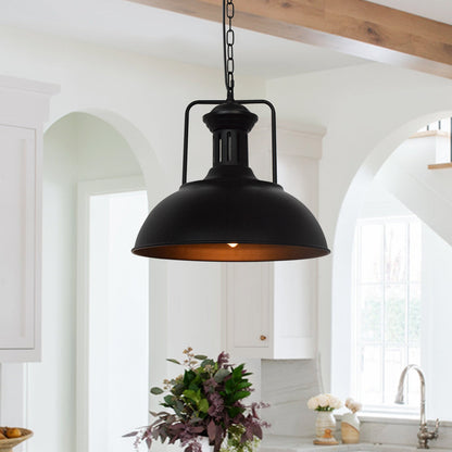Hugo black dome pendant light with warm glow in a bright kitchen