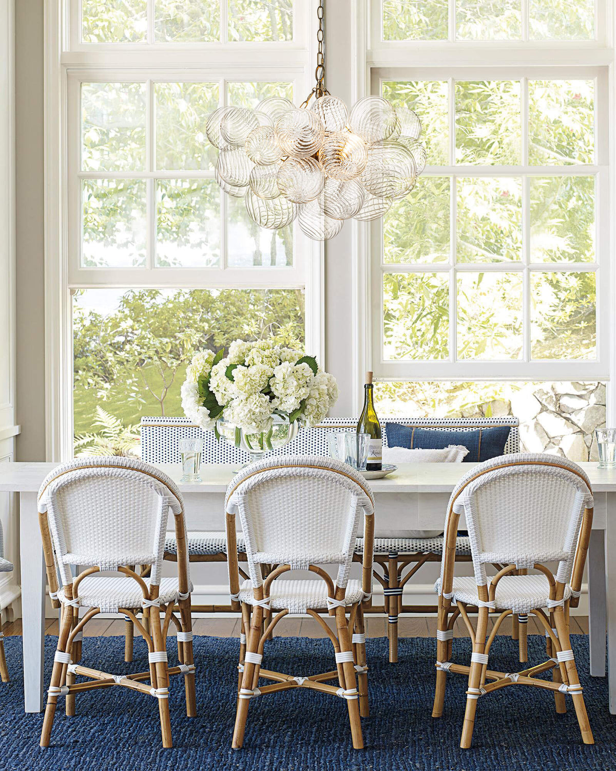 Annika bubble chandelier – over a dining table with rattan chairs
