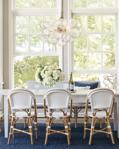 Annika bubble chandelier – over a dining table with rattan chairs