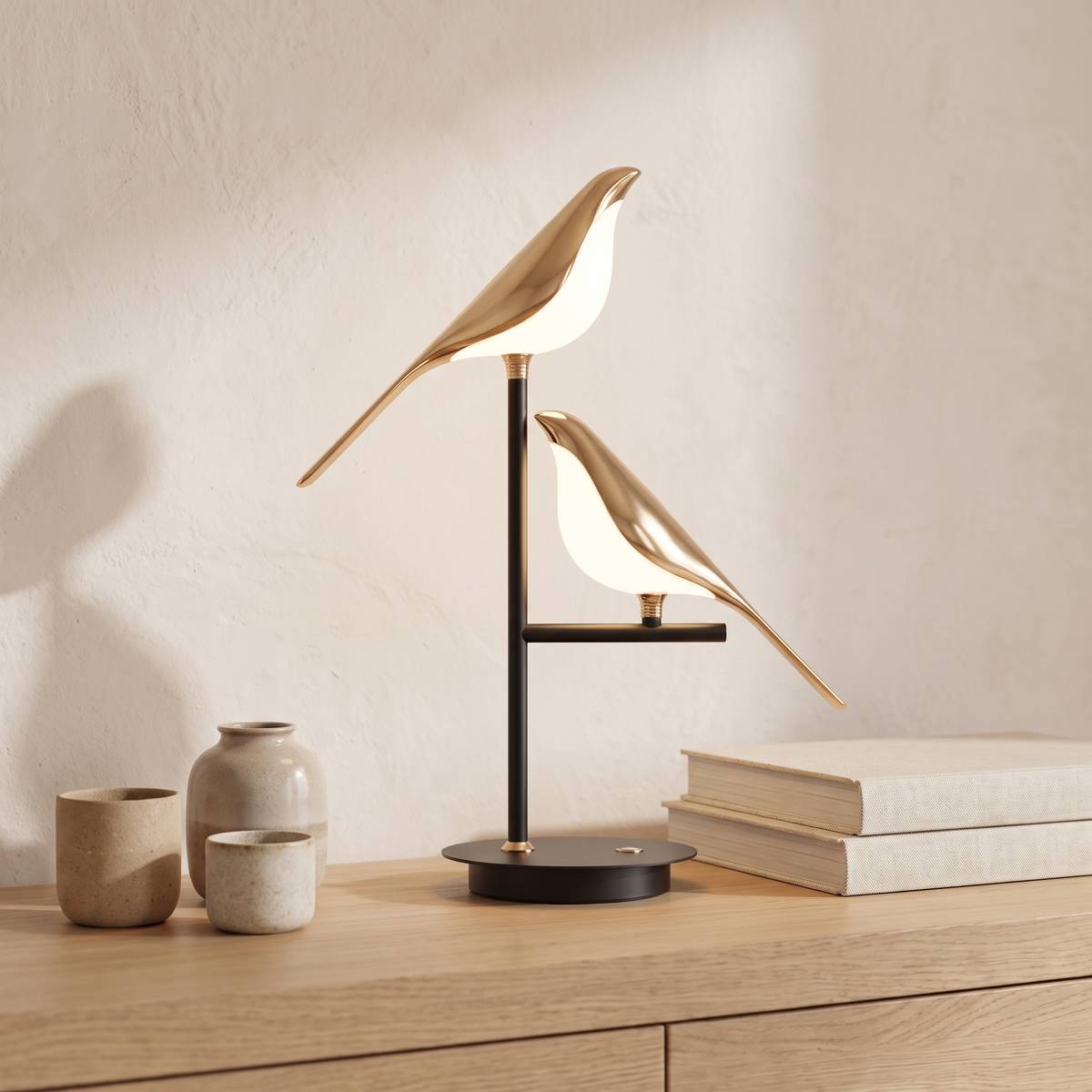 Close detail of the Avelle gold bird table lamp on a pale oak credenza