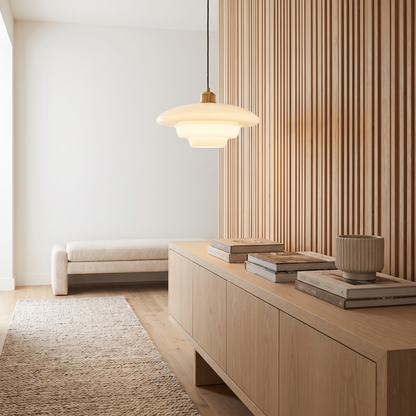 Brassa pendant light above a console in an entry hall