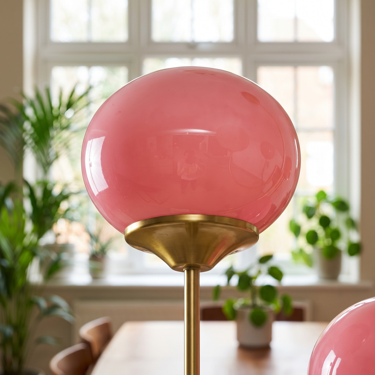 Close-up of a Margaux hand-sprayed pink glass globe
