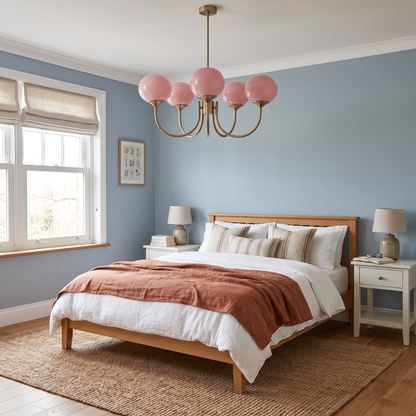 Margaux pink glass chandelier above a bed