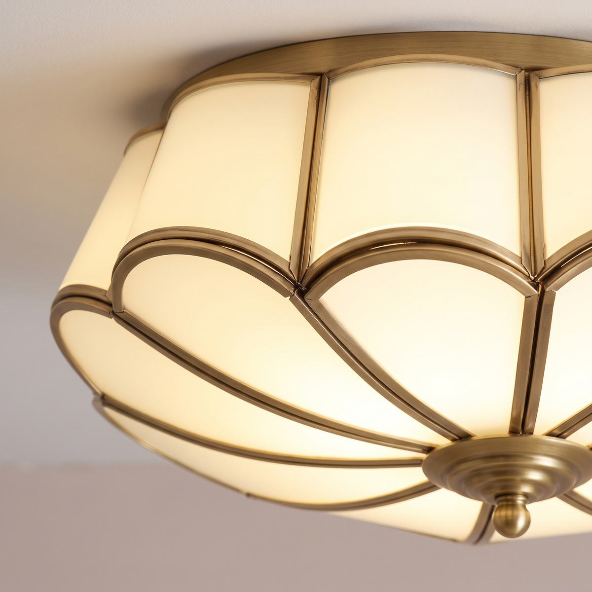 Close-up of Rosalind opal glass petals and brass ribs, lit