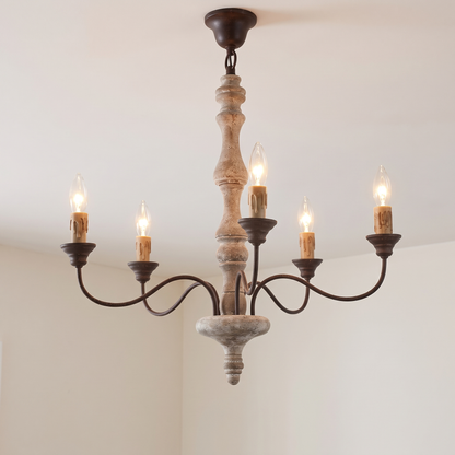 Amalia rustic candle chandelier, 5-light with brown candles, lit, hanging from a white ceiling