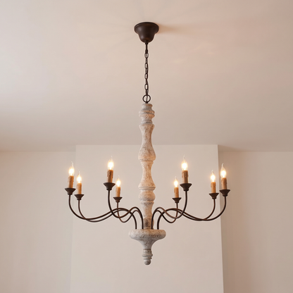 Amalia rustic candle chandelier, 8-light with brown candles, lit, hanging from a white ceiling