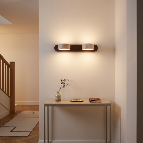 Livia travertine wall light – glowing in a hallway