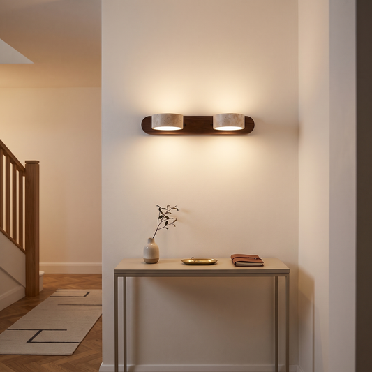 Livia travertine wall light – glowing in a hallway