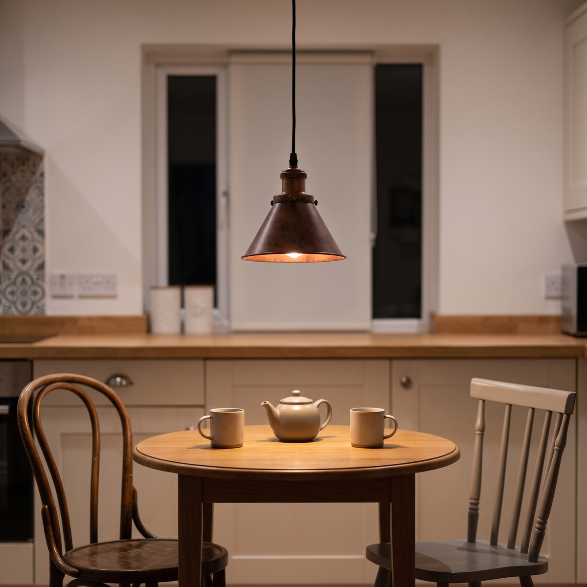 Carlotta copper cone pendant – glowing above a bistro table