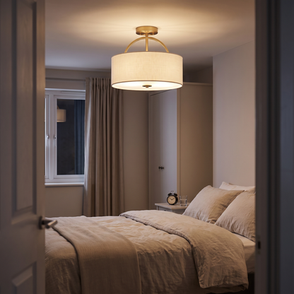 Isadora linen drum ceiling light – glowing in a bedroom