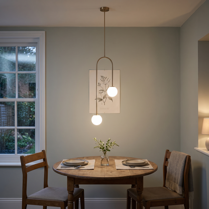 Mirabel twin globe pendant – glowing above a small dining table