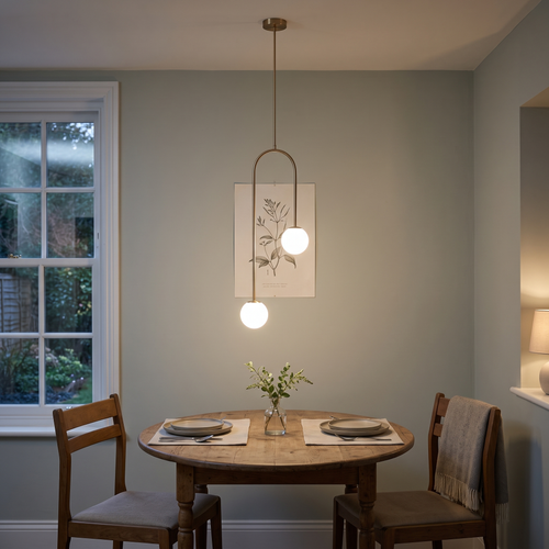 Mirabel twin globe pendant – glowing above a small dining table