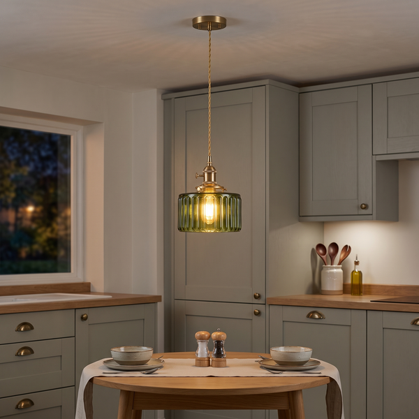 Juliette green ribbed glass pendant – glowing above a bistro table