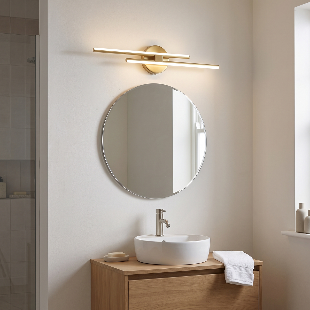 Cosimo gold linear vanity light – glowing above a bathroom mirror