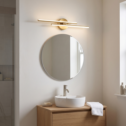 Cosimo gold linear vanity light – glowing above a bathroom mirror