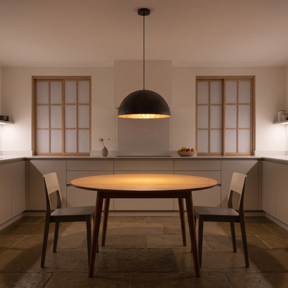 Octavia dome pendant with gold interior – glowing above a kitchen table