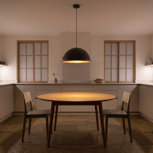 Octavia dome pendant with gold interior – glowing above a kitchen table
