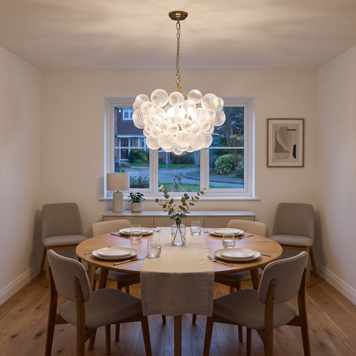 Annika ribbed glass bubble chandelier – glowing above a dining table