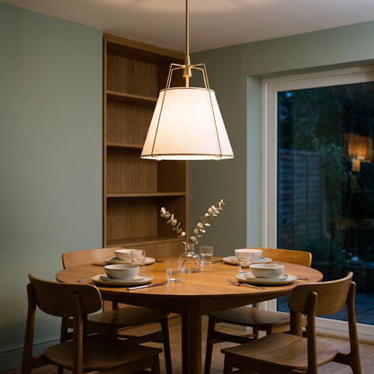 Ophelia linen pendant – glowing above a round dining table