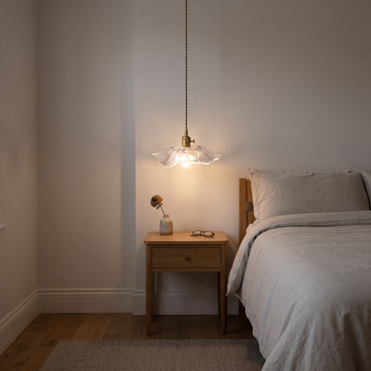 Ondine lotus glass pendant – glowing beside a bed