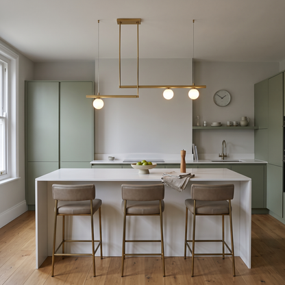 Vittoria brass linear globe chandelier – glowing above a kitchen island