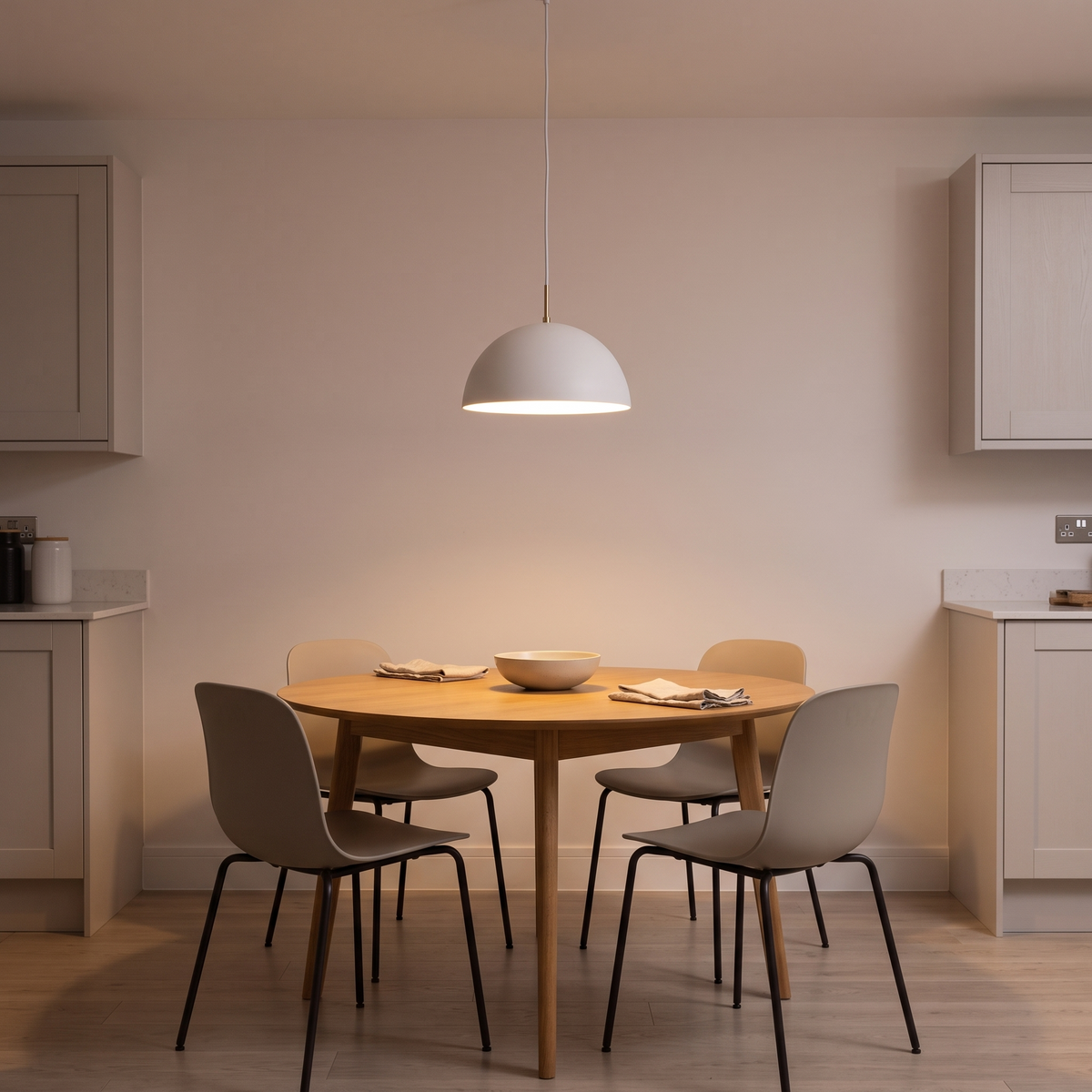 Dorian white dome pendant – glowing above a kitchen table