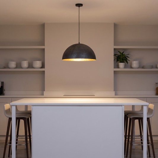 Augustin dome pendant with gold interior – glowing above a kitchen island