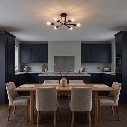 Cyrus black sputnik ceiling light – glowing above a kitchen table