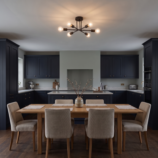 Cyrus black sputnik ceiling light – glowing above a kitchen table