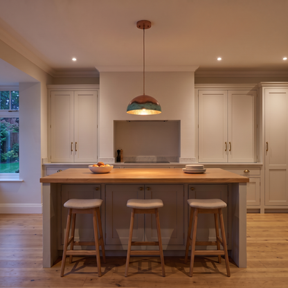 Caspian copper dome pendant – glowing above a kitchen island