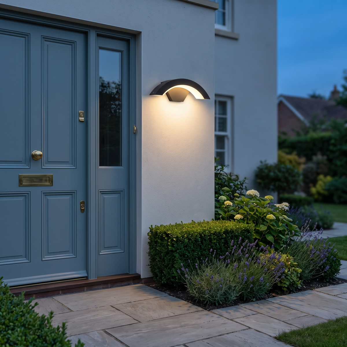 Cormac curved LED outdoor wall light – glowing beside a front door