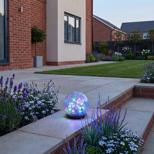 Ewan crackle glass solar orb – glowing on a garden step