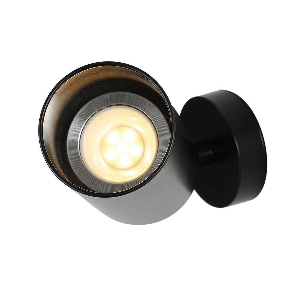 Remy adjustable spot ceiling light – black lens lit close-up