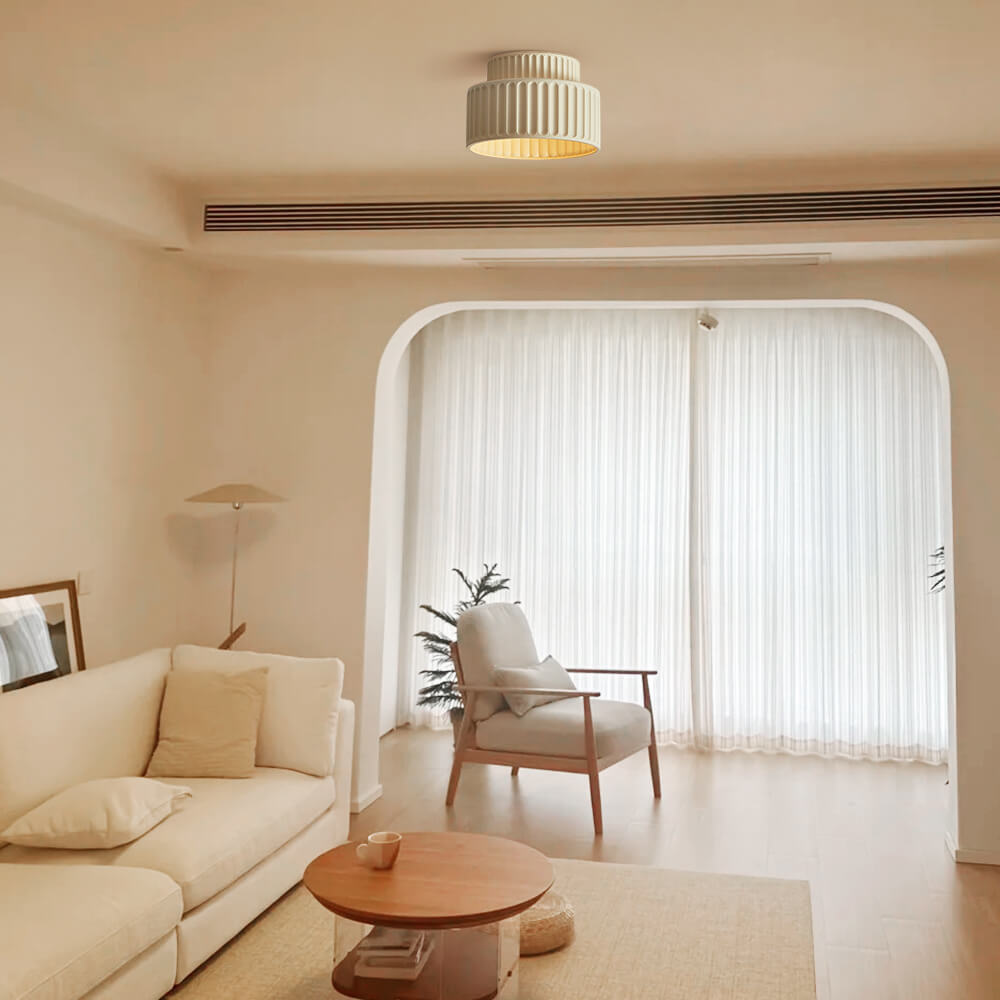 Colette ribbed resin ceiling light – in beige in a living room with an arch