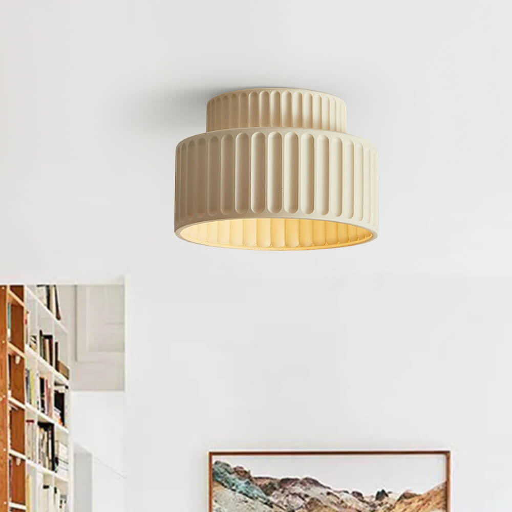 Colette ribbed resin ceiling light – in beige in a living room with bookshelves