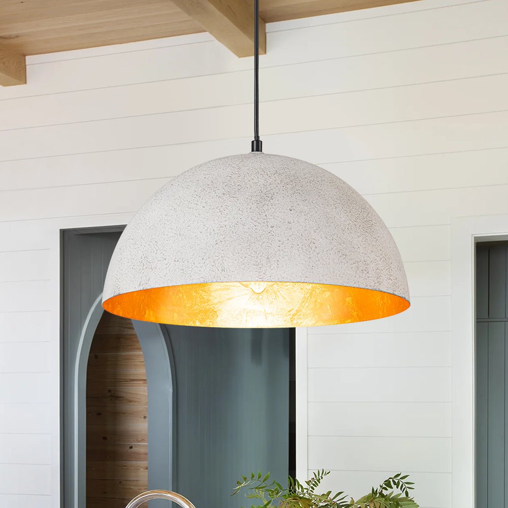 Octavia oversized dome pendant – white dome with gold interior by a wooden wall