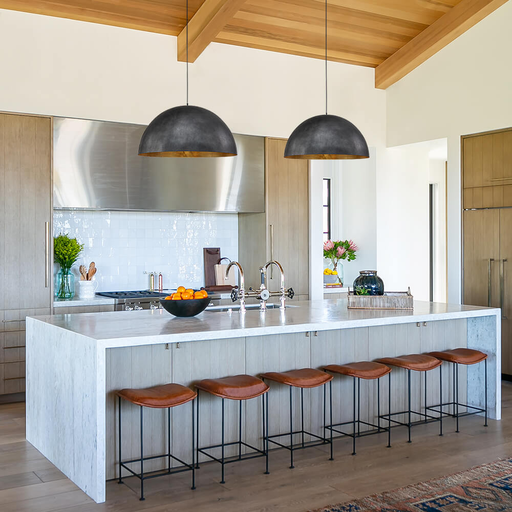 Octavia oversized dome pendant – two black domes over an island with a wooden ceiling