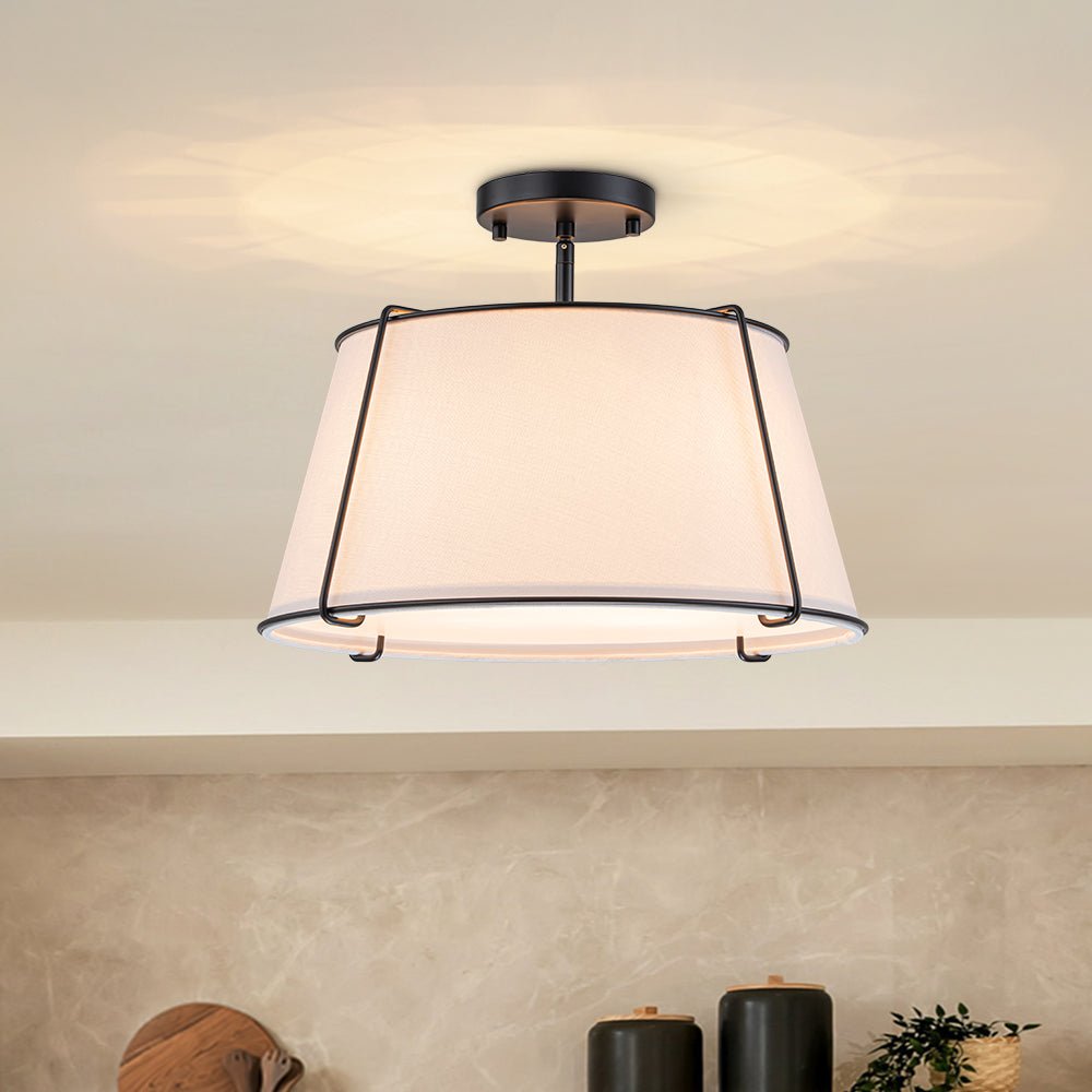 Theodora tapered drum ceiling light – with black frame in a neutral room