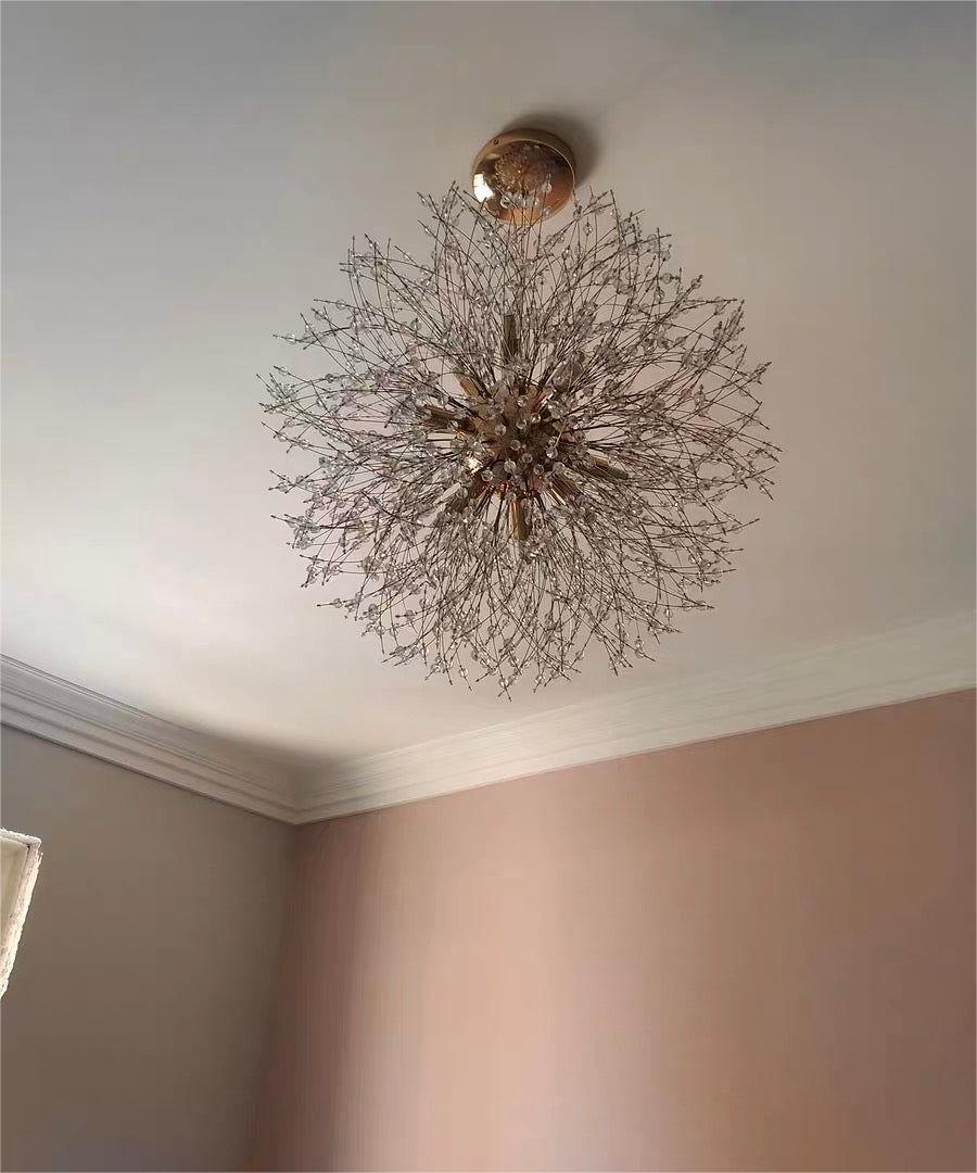 Delphine firework crystal chandelier – in gold on a ceiling, lit