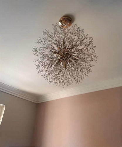 Delphine firework crystal chandelier – in gold on a ceiling, lit
