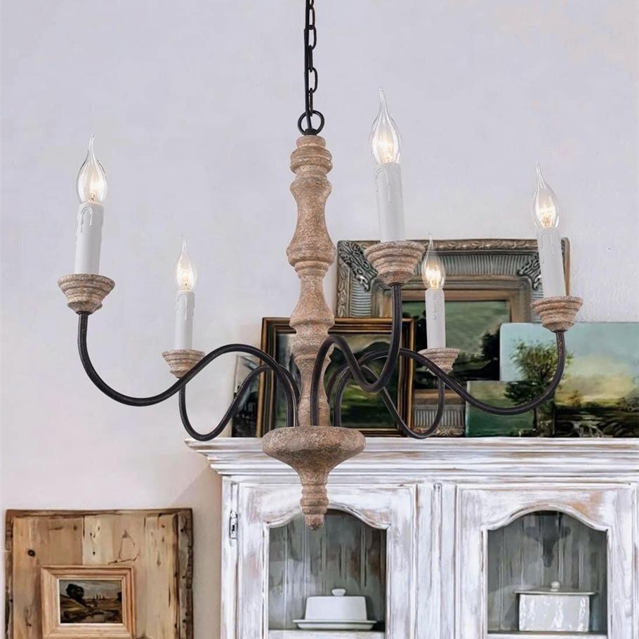 Amalia rustic candle chandelier above a distressed white dresser