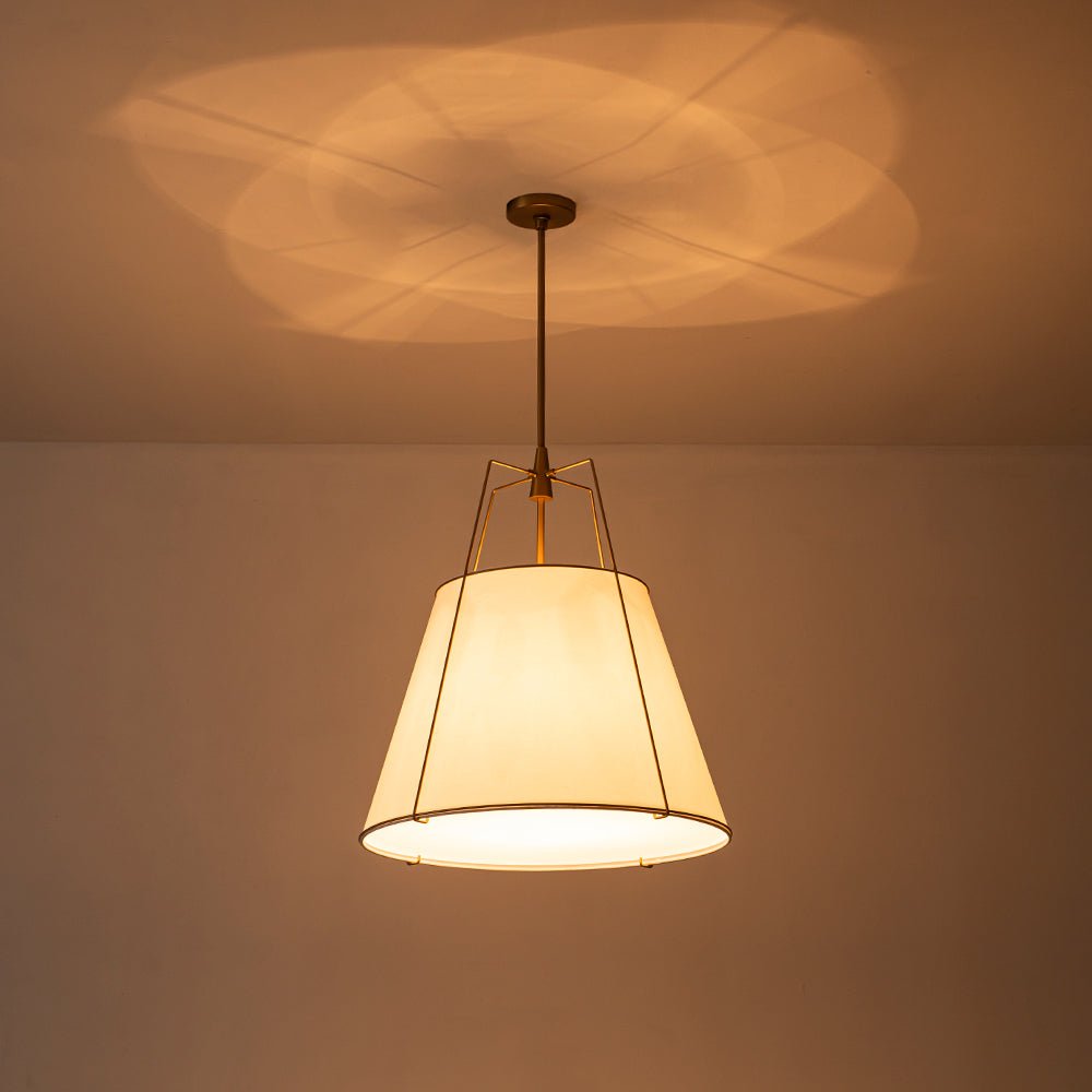 Ophelia tapered linen pendant – lit with a warm glow