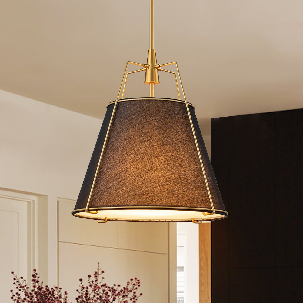 Ophelia tapered linen pendant – black shade with brass frame against a dark wall