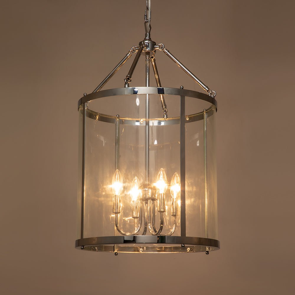 Tristan glass lantern chandelier – lit in a warm room