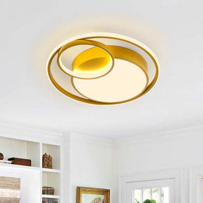 Elowen double ring LED ceiling light – in gold, lit in a living room