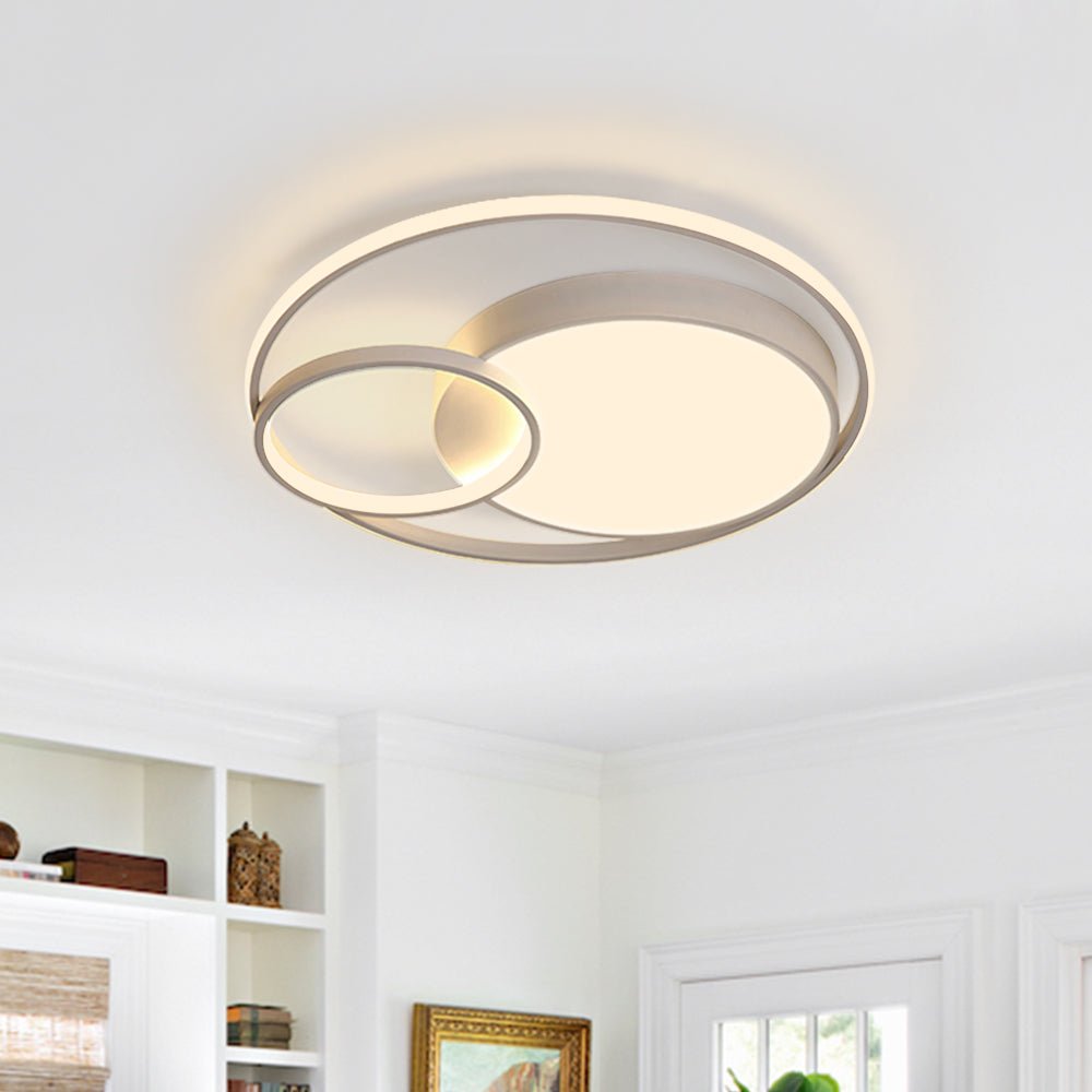 Elowen double ring LED ceiling light – in white, lit in a living room