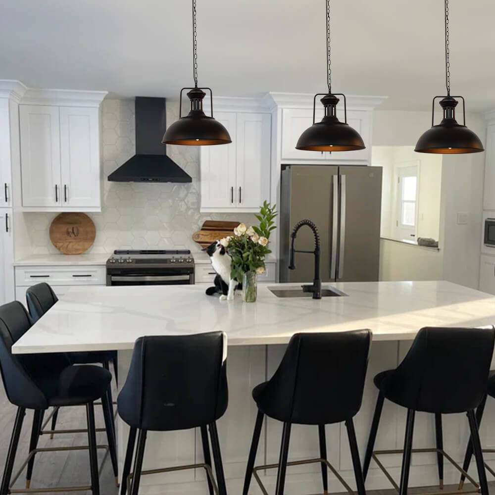 Hugo black dome pendant lights hanging above a kitchen island with black stools
