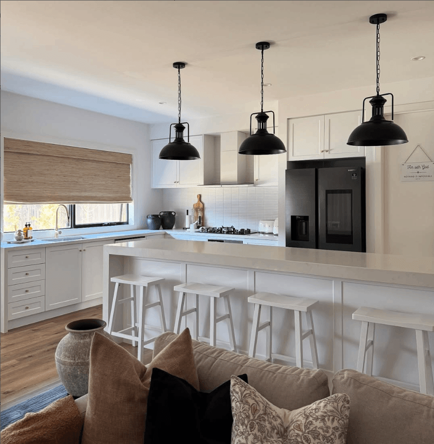 Three Hugo black dome pendant lights over a white kitchen island