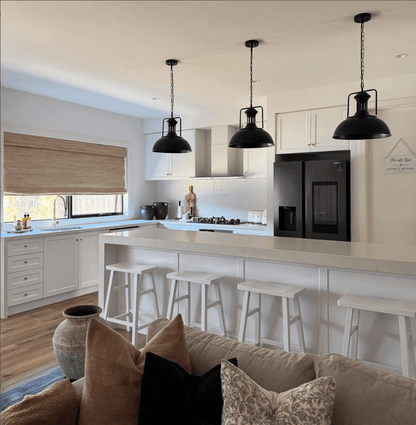 Three Hugo black dome pendant lights over a white kitchen island