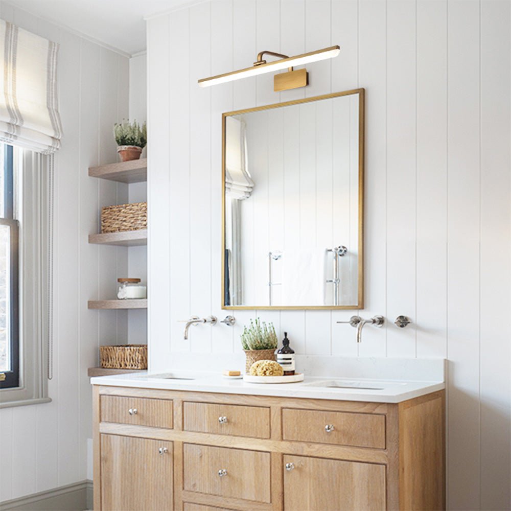 Cosima gold LED vanity light – above a wooden vanity